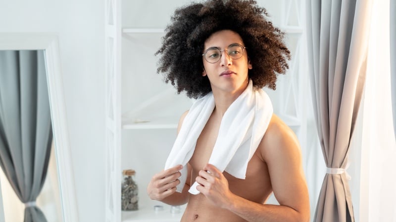 man drying curly hair towel