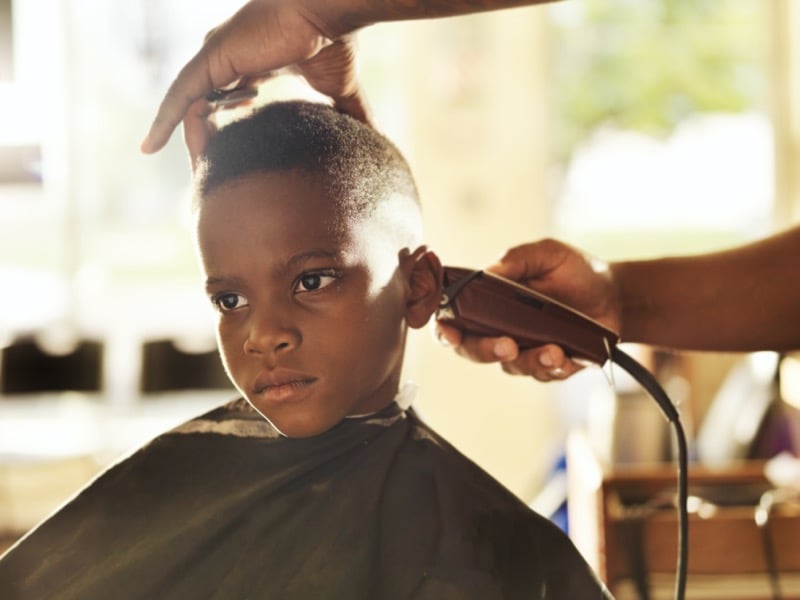 Black boy with a buzz cut and more length on top