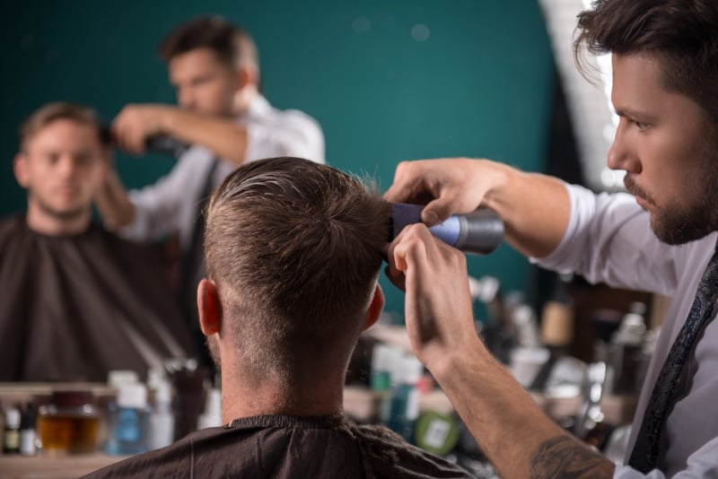 barber holding hair clippers