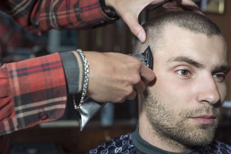 barber giving a man a buzz cut