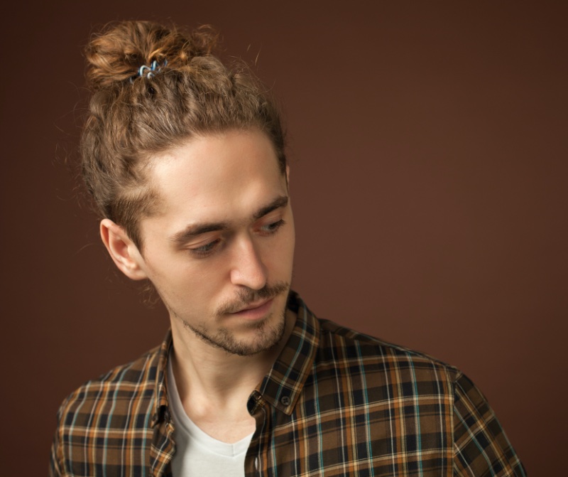 curly hair man bun