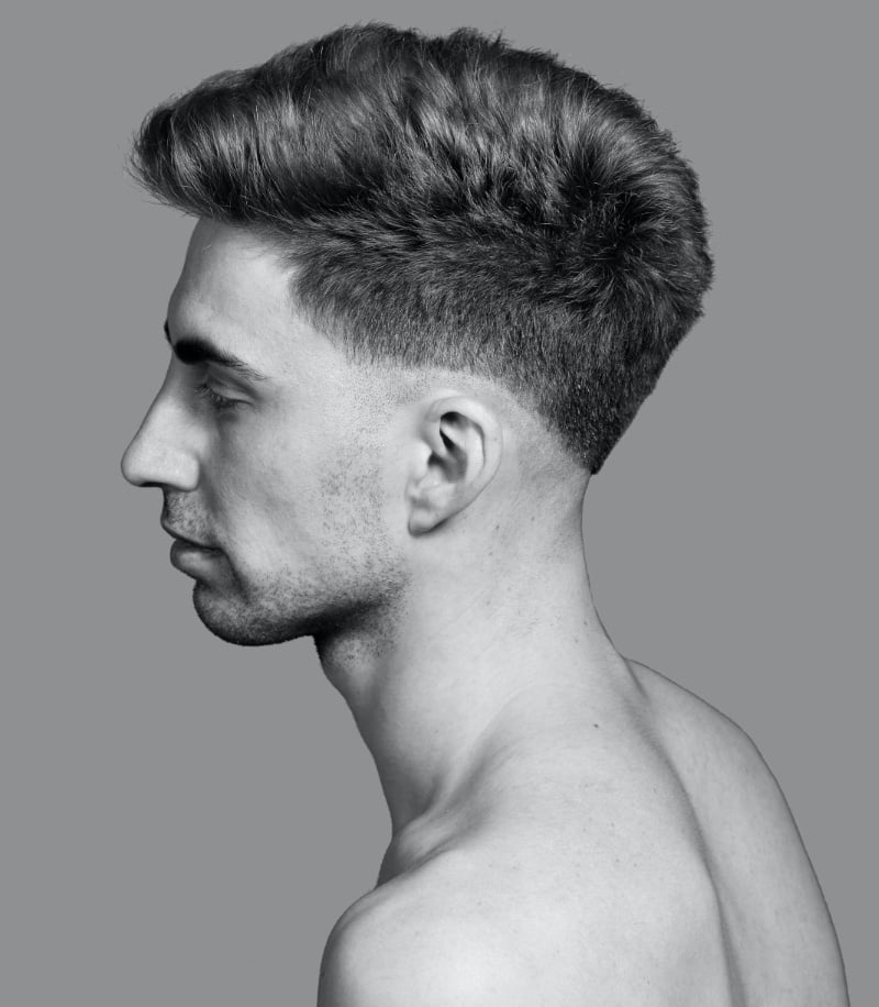 textured pompadour with low fade, side view