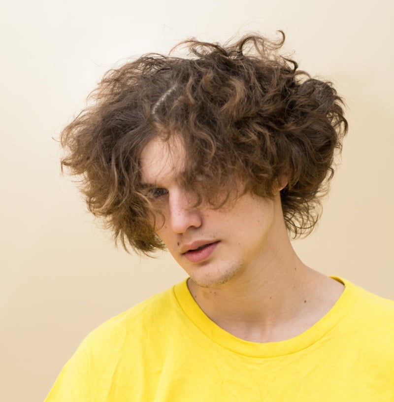 messy curly wolf cut men