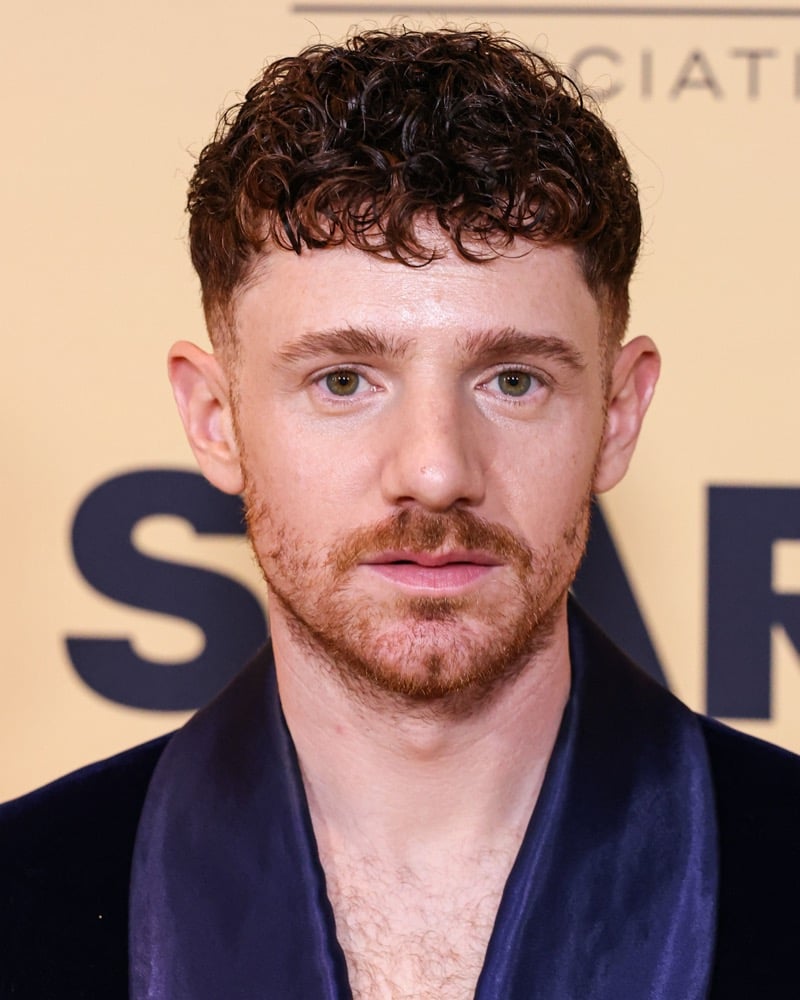 Chris Perfetti with a curly French crop and drop fade