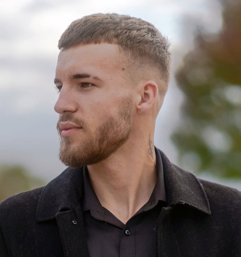 French crop with short fringe and full groomed beard