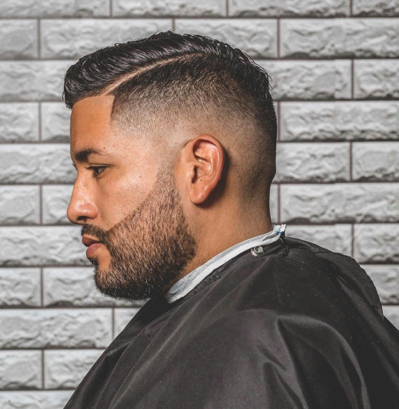 barber blending a blurry fade with clippers