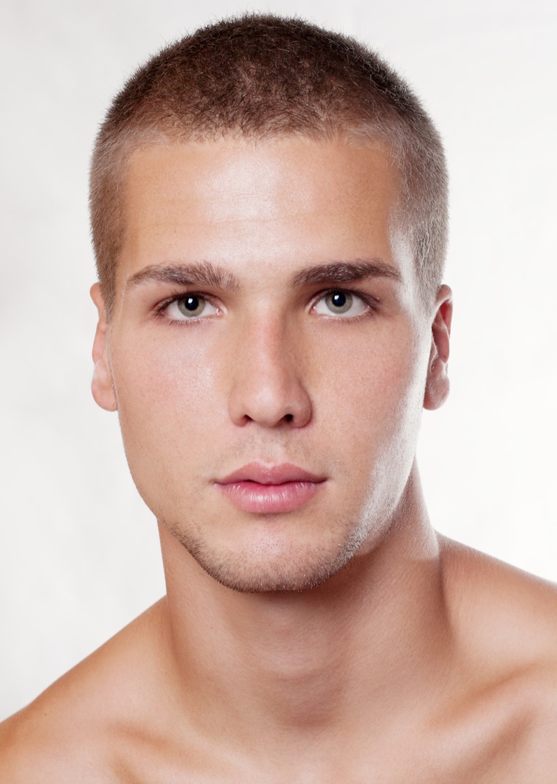 Man with a 3 guard buzz cut and natural hairline viewed from the front
