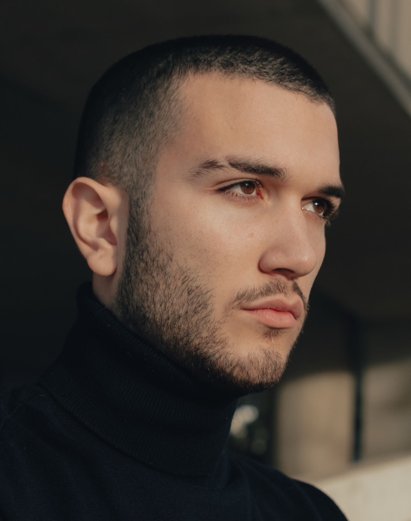 Man with a 3 guard buzz cut and mid fade
