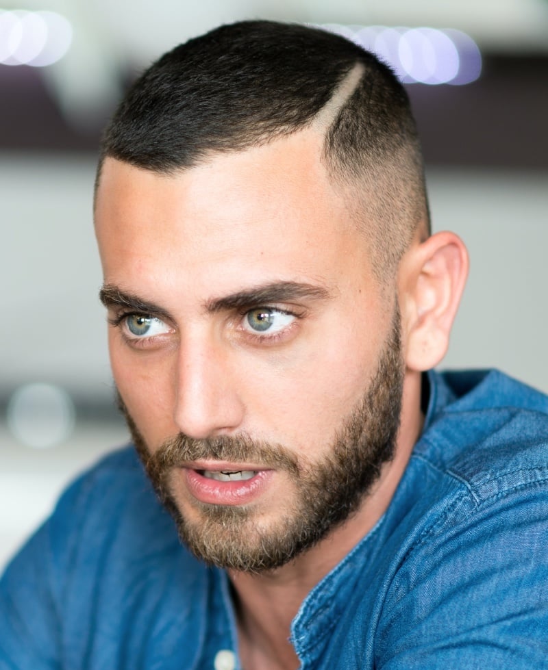Man with a high fade crew cut and a shaved hard part